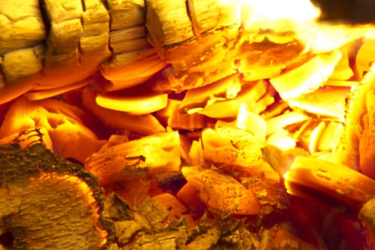 Fire place detail of a fire burning inside.