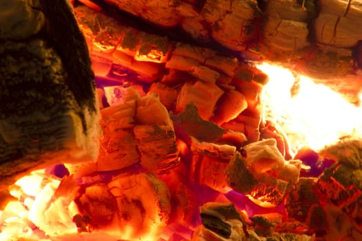 Fire place detail of a fire burning inside.
