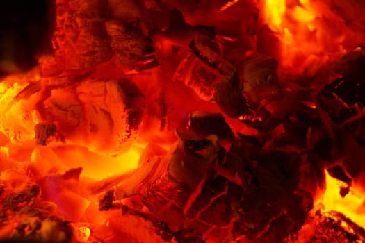 Fire place detail of a fire burning inside.