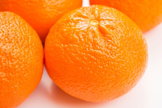 Vibrant mandarin fruit on a white background.
