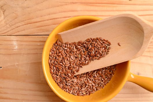Flaxseed in a ceramic bowl on a wooden table