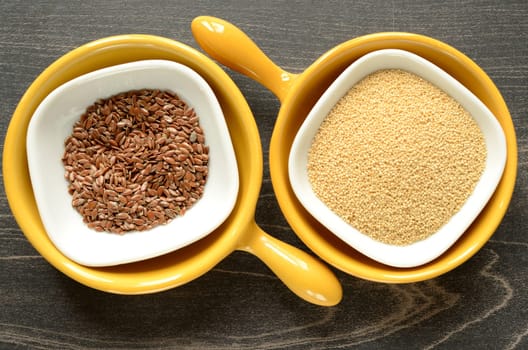 Flax seed and amaranth in a ceramic bowl on a dark wooden background