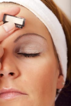 Young woman with headband during makeup