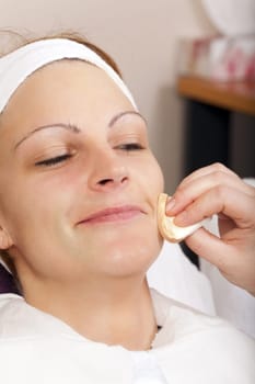 Young woman smiles at cosmetic treatment