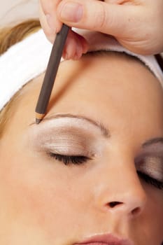Eyebrows are traced with kajal pencil