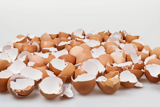 Pile of many broken brown empty eggshells