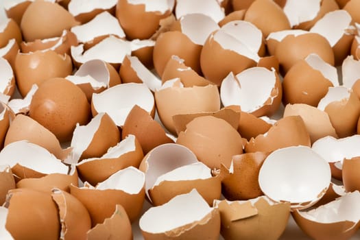 Background of many broken brown empty eggshells