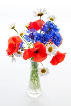 Bouquet of wildflowers - poppies, daisies, cornflowers - on white background, studio shot.