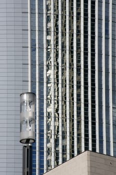 The photograph of a lantern in front of a modern house facade.