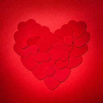 Romantic heart made of many smaller red paper hearts for valentines day