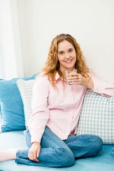 Smiling caucasian woman relaxing with glass of water
