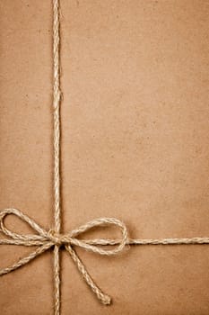 Brown paper gift package background with twine and copy space