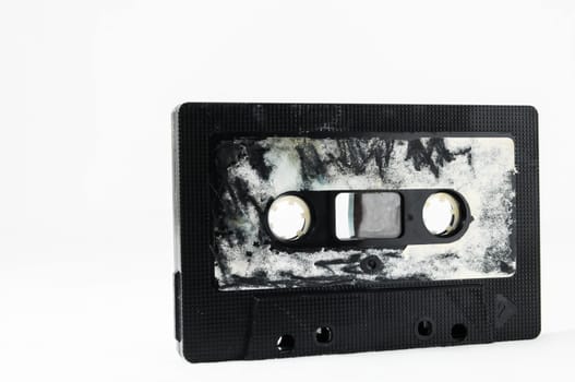 Ancient Vintage Used Musicassette over a White Background
