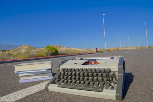 On the Road Writing Concept Typewriter over an Asphalt Street