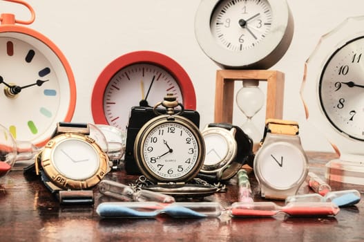 Many Different Clocks on a Woden Table