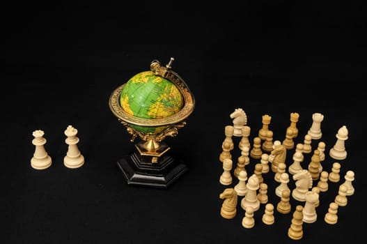 Globe And White Chess on a Black Background