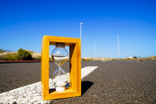 Time Concept Hourglass on the Asphalt Street