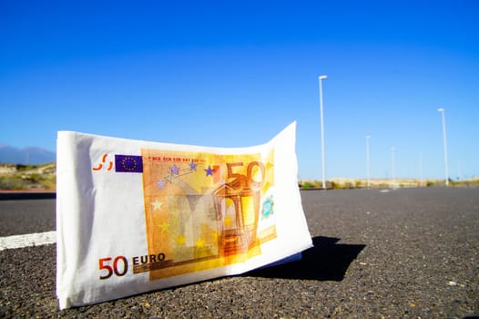 Business Money Concept Banknotes(paper) on the Asphalt Street