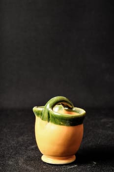Colorful designed clay vase over a Black background