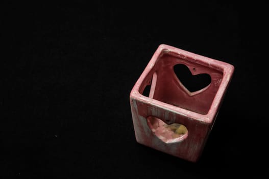 Colorful designed clay vase over a Black background