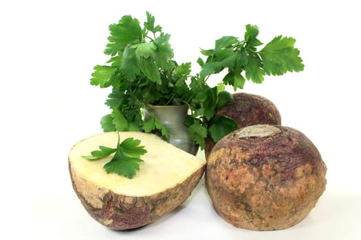 two turnips and parsley against a white background