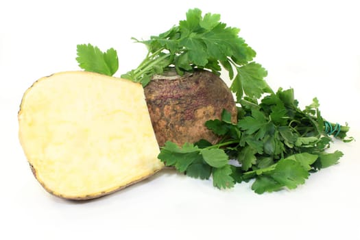 two turnips and parsley against a white background