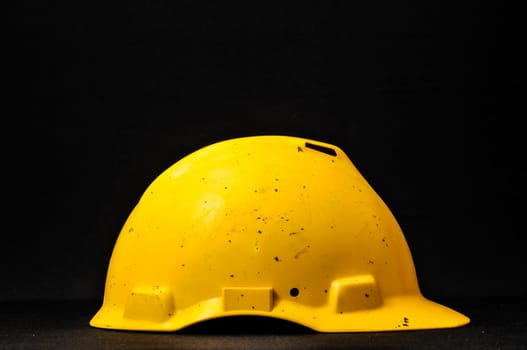Yellow Safety Helmet on a Black Background