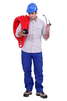 Plumber holding piggy-bank and tap