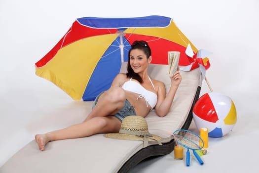 Woman laying on sun lounger
