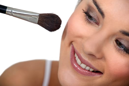 Woman applying makeup
