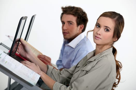 Smart young people using laptop computers