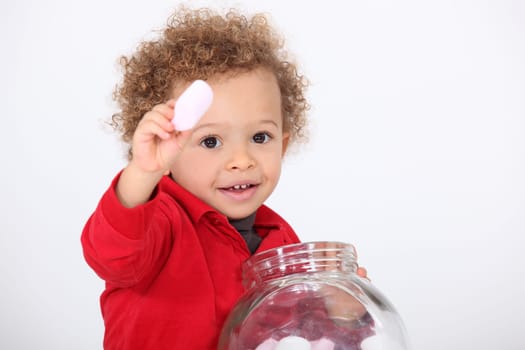 Little boy eating sweets