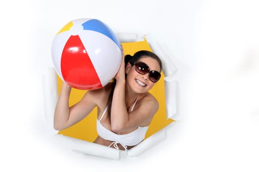 Woman in bikini with an inflatable ball.