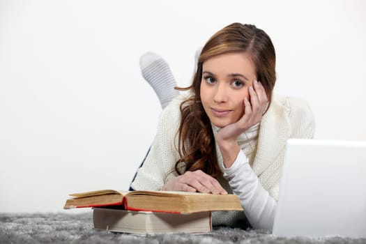 female student with books and laptop