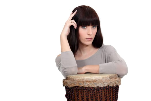 Pensive woman resting on a drum