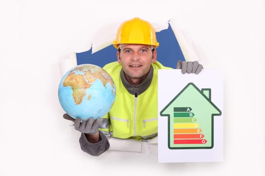 Tradesman holding a globe and an energy efficiency rating chart