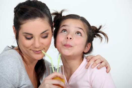 Mother and daughter sharing a drink