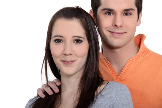 Young couple playing a guitar at home