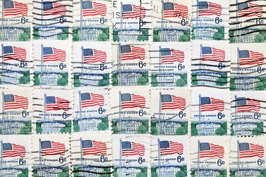 background of used US postage stamps