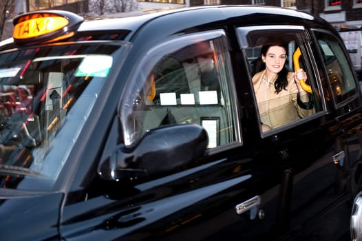 Happy female passenger inside of a taxi
