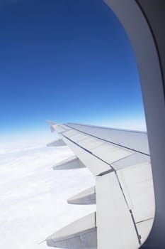 Airplane window looking out over the wing. Vertically.