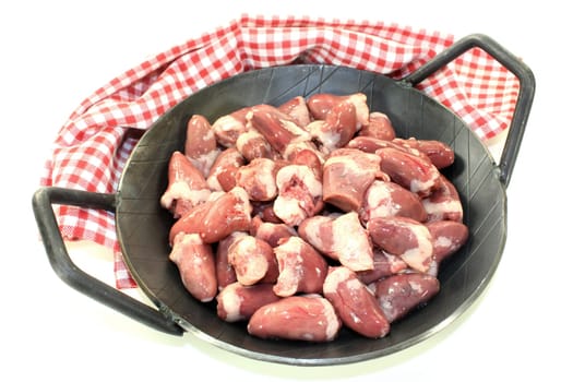 fresh raw chicken hearts against a white background