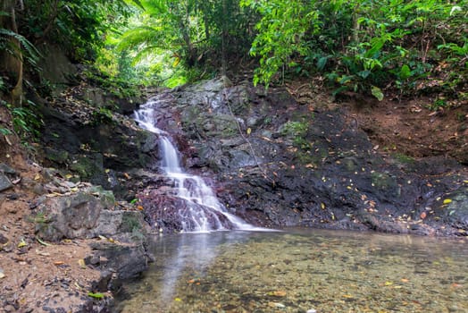 Small waterfall in a dense tropical rainforest near Capurgana, Colombia