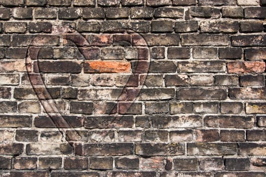 Image of the heart on the old broken brick wall