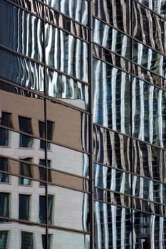 The abstract photography of high-rise and building reflections in mirrored windows.