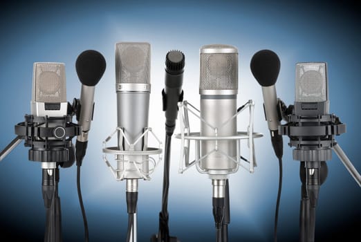Studio recording from a set of professional microphones against a blue background