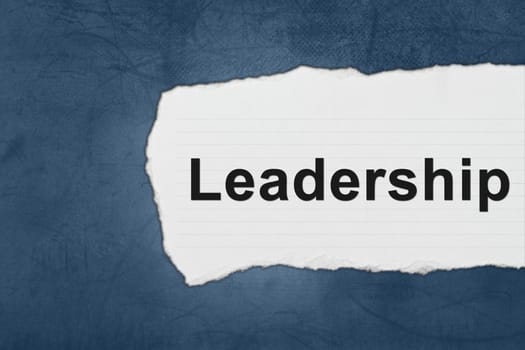 Leadership with white paper tears on blue texture