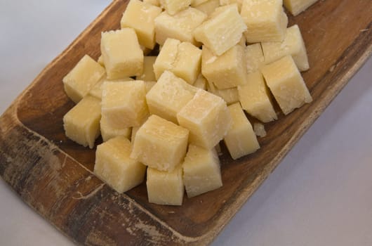 Cubes of aged sheep cheese on a wooden tray, Caceres, Spain