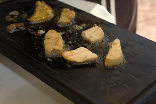 Close up frying foie gras on the griddle