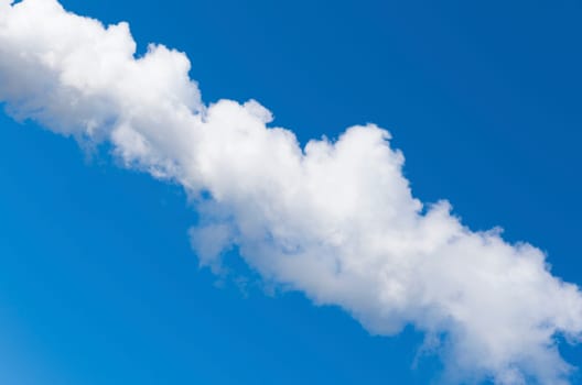 line of white smoke against a blue sky
